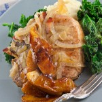 Cider-braised Pork Chops with Caramelized Onions and Chipotle-glazed Apples, Horseradish Mashed Potatoes and Sautéed Kale