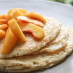 Sourdough pancakes topped with peaches, a perfect way to start the day