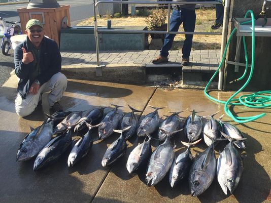 I pose for a picture with the boat's catch of the day. The two albacore that I caught are nearest me.